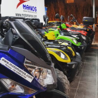 colourful photo of quads and scooters parked in front of our office in perissa santorini
