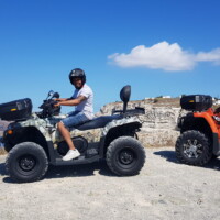 couple on two atvs rented from moto manos santorini